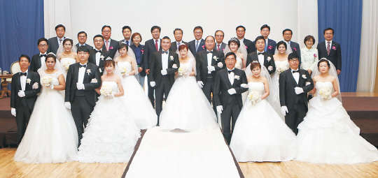 지난 12일 삼성전자 수원 디지털시티에서 열린 '사랑의 합동결혼식'에서 수원지역 부부 9쌍과 염태영 수원시장(맨뒷줄 왼쪽 여섯번째부터), 김훈동 대한적십자사 경기도지사 회장, 박광온 국회의원 등이 단체사진을 촬영하고 있다. 삼성전자 제공
